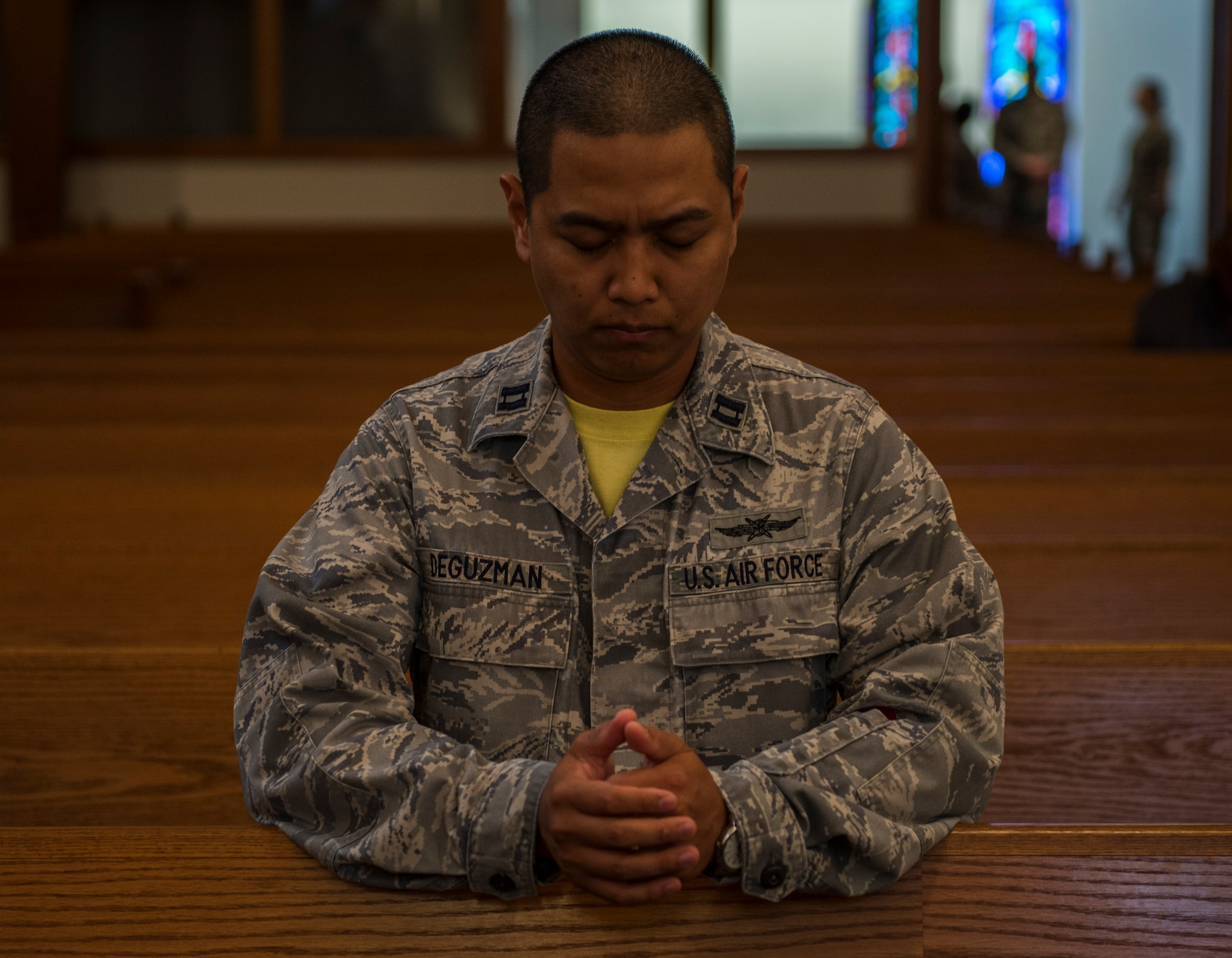 Capt. Robin Deguzman, Air Force Space Command Cyberspace Support Squadron, prays during an interfaith prayer service, Scott Air Force Base, July 15, 2016. The Scott Air Force Base chapel held the prayer service in response to the shootings in Orlando, Falcon Heights, Baton Rouge, Dallas, and the attack that killed 84 in Nice, France.   The service included representatives from at least six religions, including the Hindu, Protestant, Islamic, Soka Gakkai International Buddhist, Catholic, and Greek Orthodox faiths.  (U.S. Air Force photo by Staff Sgt. Jodi Martinez/Released)