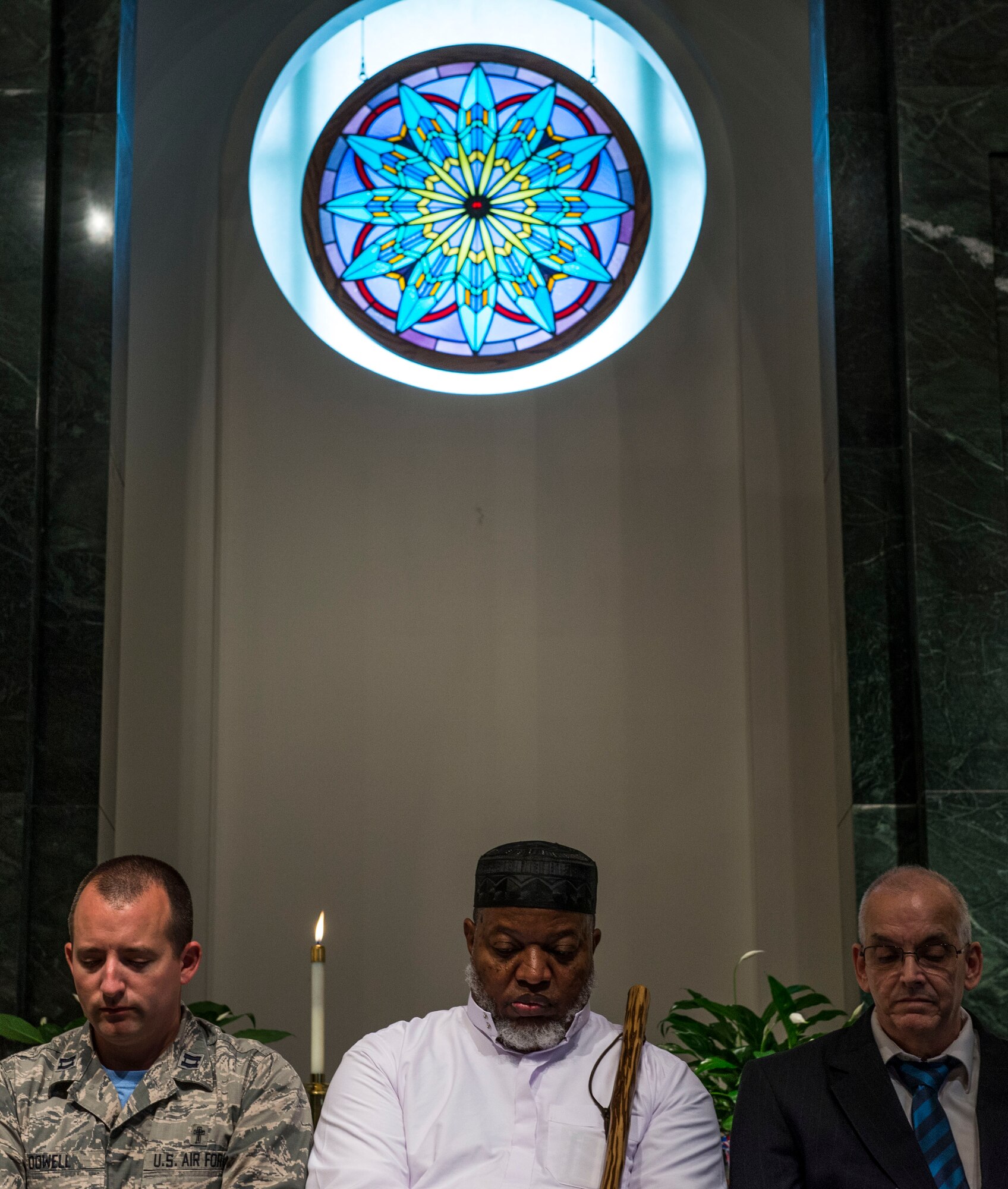Chaplain (Capt.) Eli Dowell, and Tim Missi take a moment for personal prayer during an interfaith prayer service, Scott Air Force Base, July 15, 2016. The chapel held the prayer service in response to the shootings in Orlando, Falcon Heights, Baton Rouge, Dallas, and the attack that killed 84 in Nice, France.   The service included representatives from at least six religions, including the Hindu, Protestant, Islamic, Soka Gakkai International Buddhist, Catholic, and Greek Orthodox faiths.  (U.S. Air Force photo by Staff Sgt. Jodi Martinez/Released)