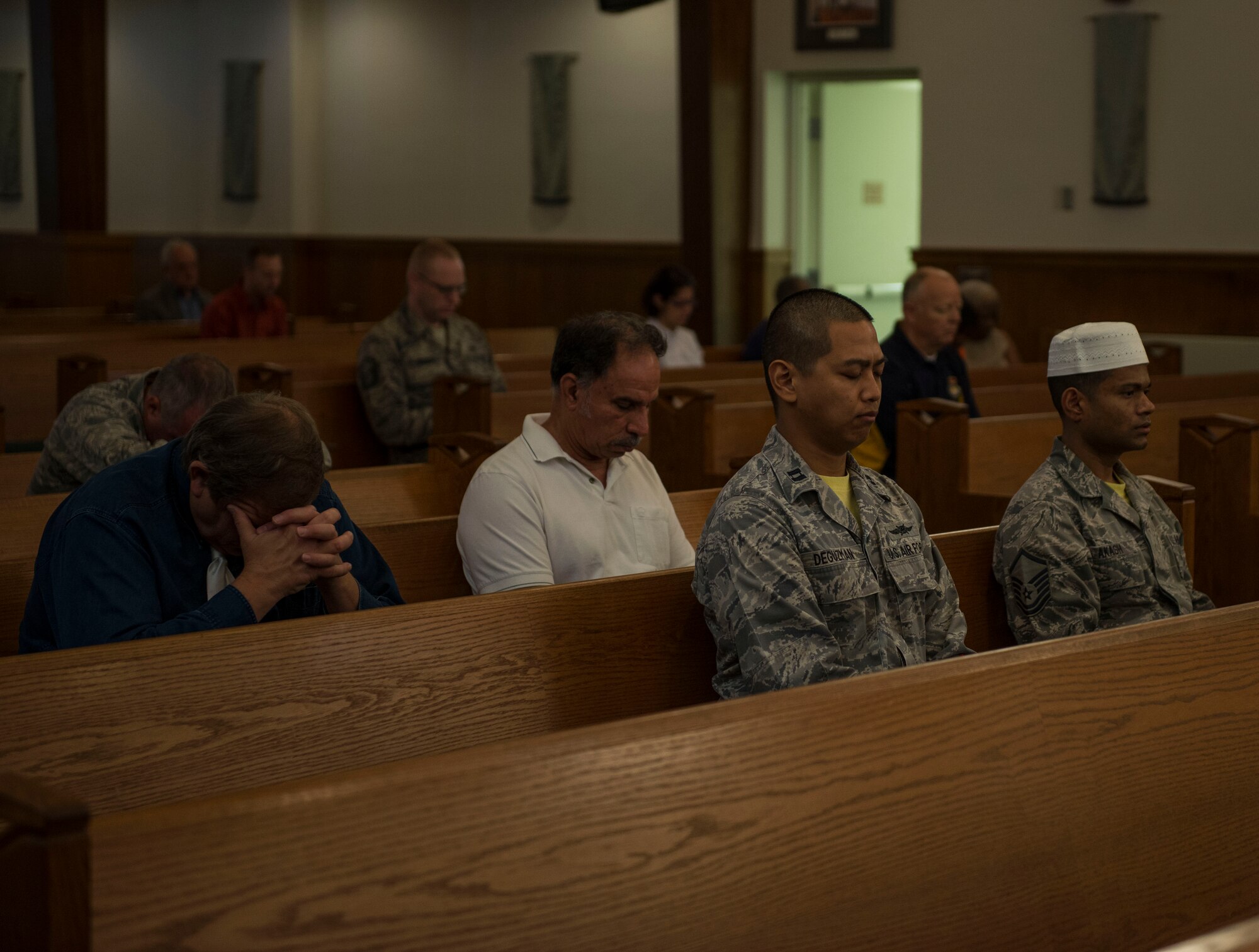 Capt. Robin Deguzman, Air Force Space Command Cyberspace Support Squadron, prays during an interfaith prayer service, Scott Air Force Base, July 15, 2016. The chapel held the prayer service in response to the shootings in Orlando, Falcon Heights, Baton Rouge, Dallas, and the attack that killed 84 in Nice, France.   The service included representatives from at least six religions, including the Hindu, Protestant, Islamic, Soka Gakkai International Buddhist, Catholic, and Greek Orthodox faiths.  (U.S. Air Force photo by Staff Sgt. Jodi Martinez/Released)