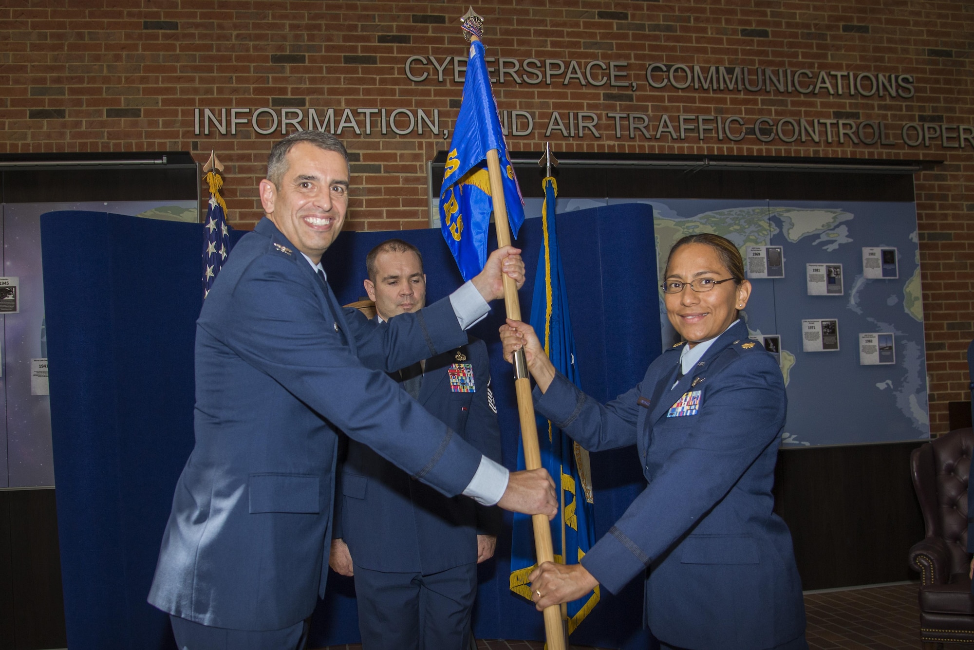 Maj. Sol Snedeker assumes command of the 38th Cyberspace Readiness Squadron and accepts the guidon from Col. Stan Diamanti, 38th Cyberspace Engineering Installation Group Commander, at Scott Air Force Base. (U.S. Air Force photo/Airman 1st Class Gwendalyn Smith)