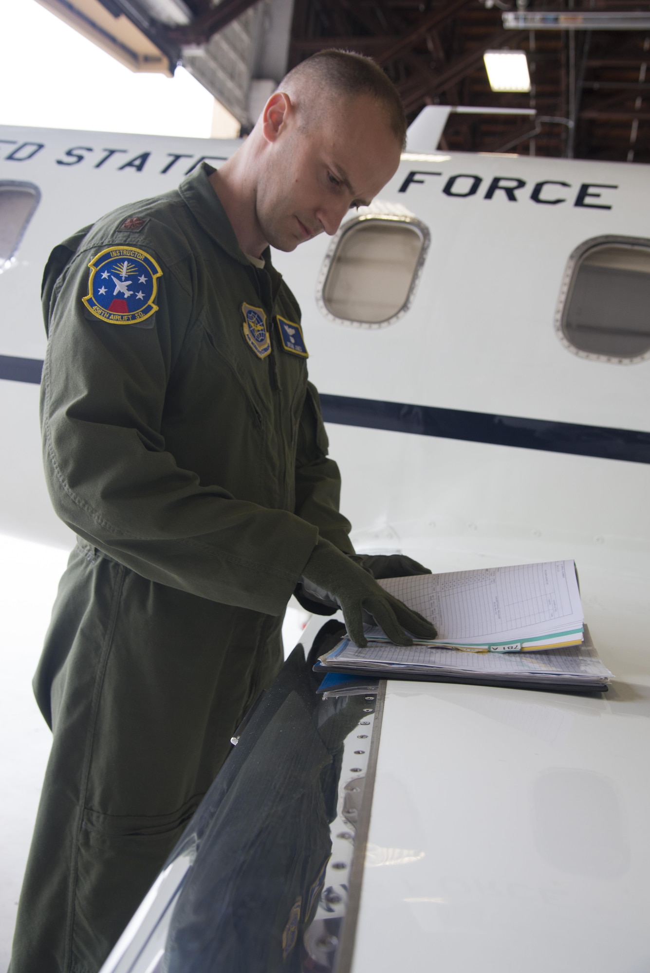 Major Brian Jones, 458th Assistant Chief of Training, works on pre-flight checks July 6, 2016 at Scott Air Force Base, Illinois. The visual inspection or walk around is done by the pilot as the final airworthiness check. (U.S. Air Force photo by Airman 1st Class Gwendalyn Smith)