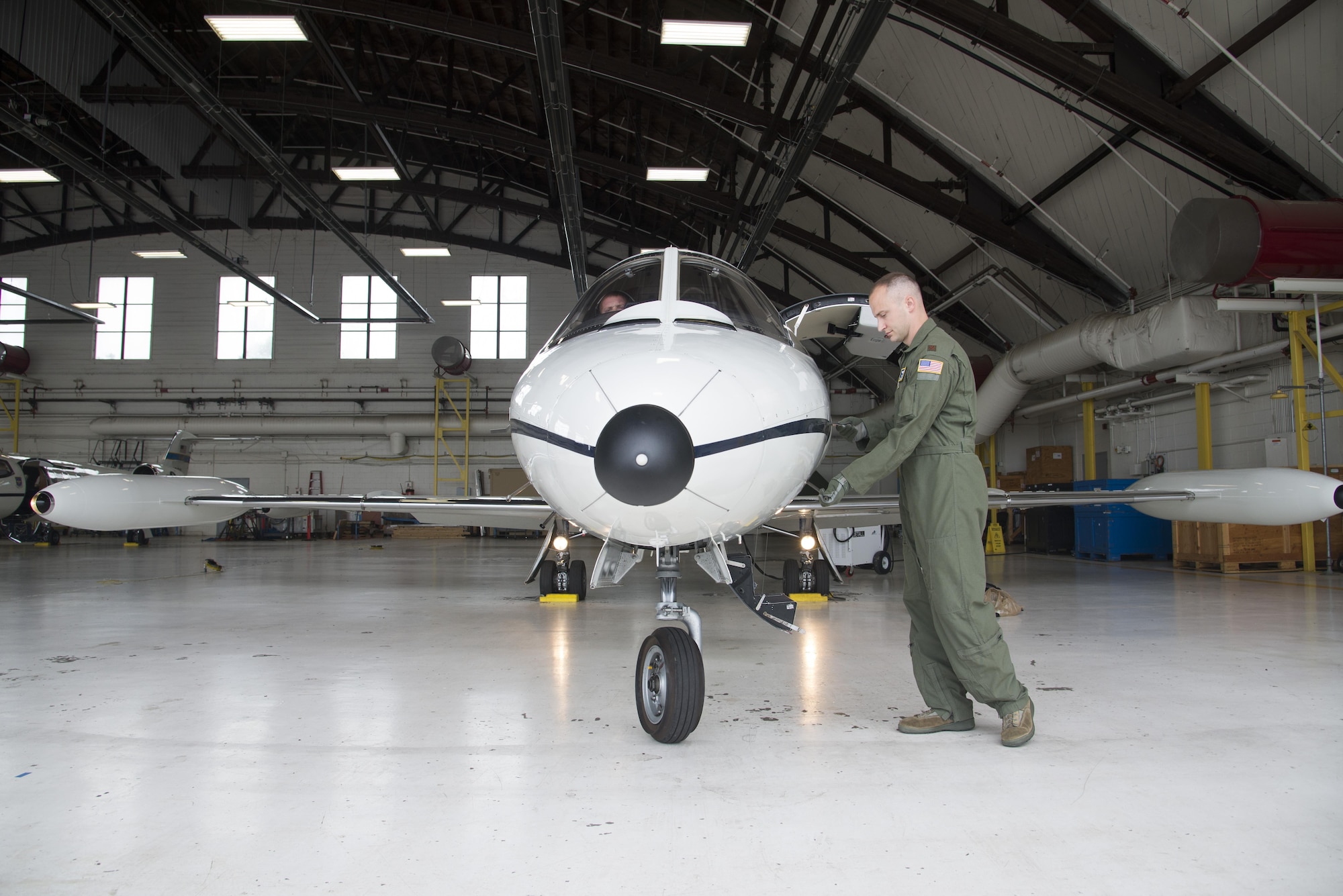 Major Brian Jones, 458th Assistant Chief of Training, works on pre-flight checks July 6, 2016 at Scott Air Force Base, Illinois. The visual inspection or walk around is done by the pilot as the final airworthiness check. (U.S. Air Force photo by Airman 1st Class Gwendalyn Smith)