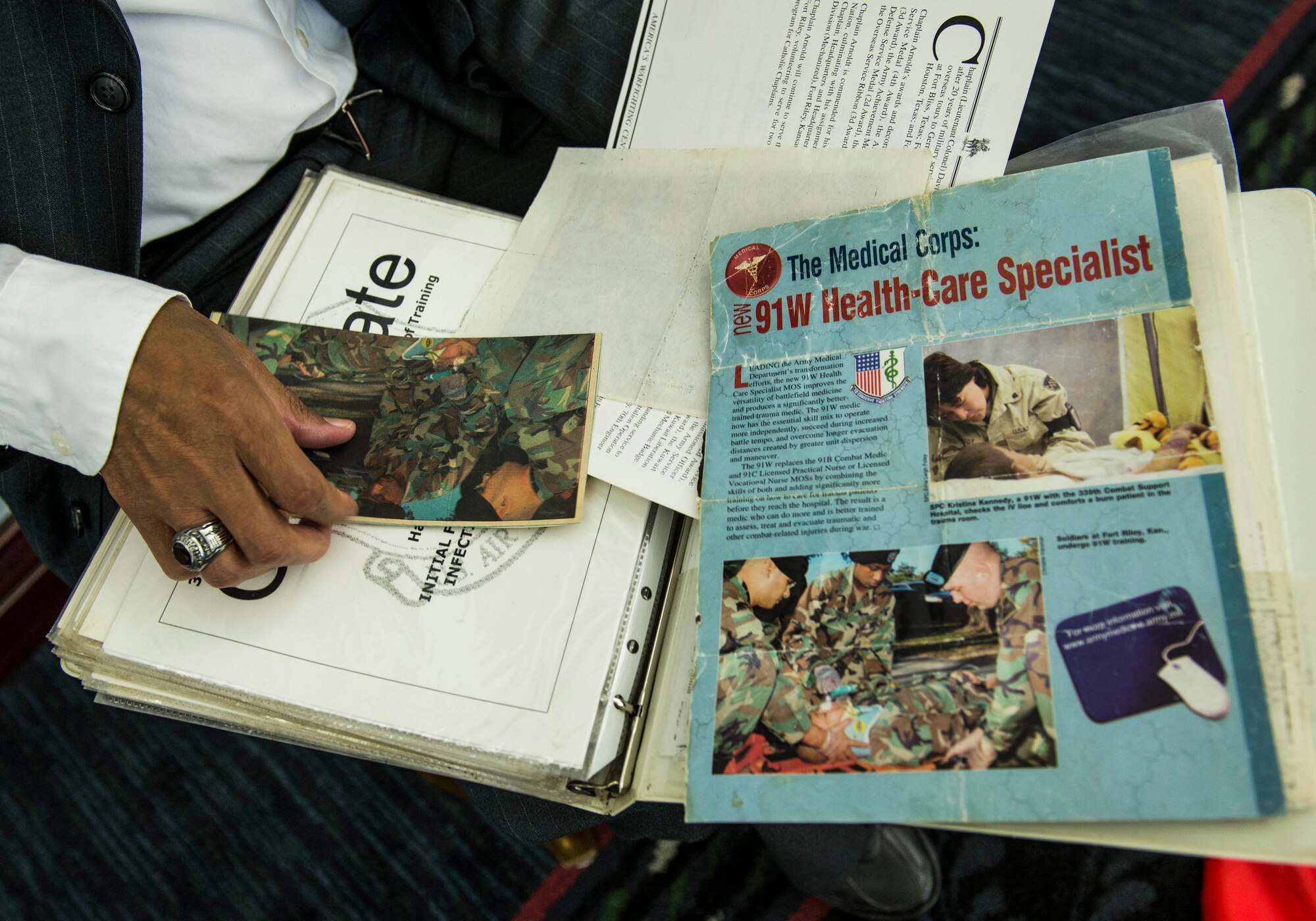 54-year-old Lavor D. White Sr., a former Army medic who served for 23 years, attends the transition summit after being out of work for over a decade due to injuries suffered while serving in the military, including a helicopter crash, an air assault accident, and a 250 ft. fall.  He brought his binder that holds all of his training certificates and important memories during his military career.  "I am willing to try anything," White said.  "I just want to get off the couch and live again." The first day of the transition summit offered industry briefs from Microsoft, the 375th Communications Group, Alcoa, Fastport, and SSM Health to transitioning service members, veterans, and military spouses, followed by a panel discussion with senior leaders of potential employers that answered questions of audience members on the transitioning process. The second day featured employment workshops, another panel discussion on different transition perspectives, and a hiring and education fair.   (U.S. Air Force photo by Staff Sgt. Jodi Martinez/Released)