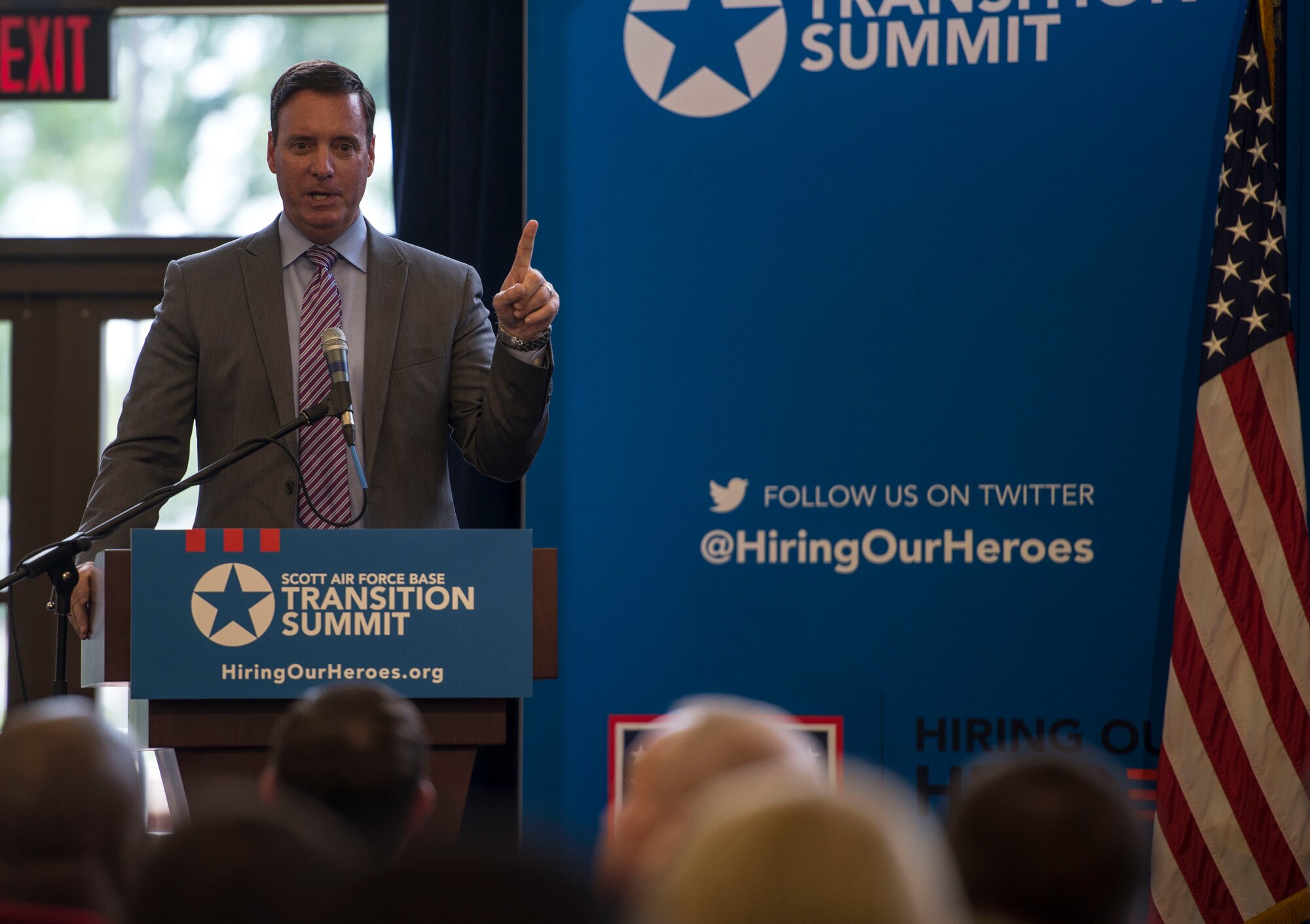 Retired Col. Chuck Hodges, Hiring Our Heroes senior director of events and programs, speaks during a two-day transition summit and hiring and education fair for transitioning members, veterans, and spouses, Scott Air Force Base, Ill., July 12, 2016.  The first day of the transition summit offered industry briefs from Microsoft, the 375th Communications Group, Alcoa, Fastport, and SSM Health to transitioning service members, veterans, and military spouses, followed by a panel discussion with senior leaders of potential employers that answered questions of audience members on the transitioning process. The second day featured employment workshops, another panel discussion on different transition perspectives, and a hiring and education fair.   (U.S. Air Force photo by Staff Sgt. Jodi Martinez/Released)