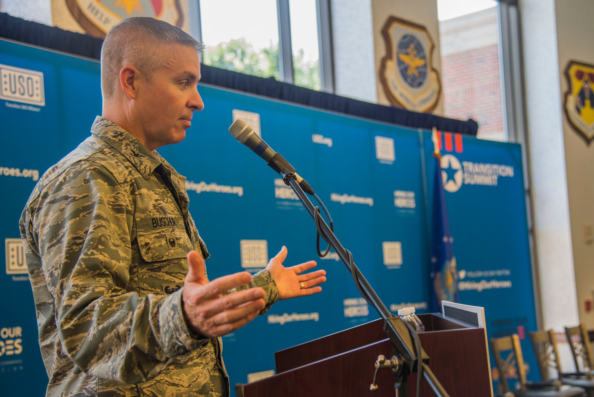 Col. William Buscher, Air Mobility Wing vice commander, welcomes venders and members of Team Scott to a free hiring fair and transition summit at Scott Air Force Base, Ill. on July 13, 2016. The first day of the transition summit offered industry briefs from Microsoft, the 375th Communications Group, Alcoa, Fastport, and SSM Health to transitioning service members, veterans, and military spouses, followed by a panel discussion with senior leaders of potential employers that answered questions of audience members on the transitioning process. The second day featured employment workshops, another panel discussion on different transition perspectives, and a hiring and education fair.  (U.S. Air Force Photo by Airman Daniel Garcia)