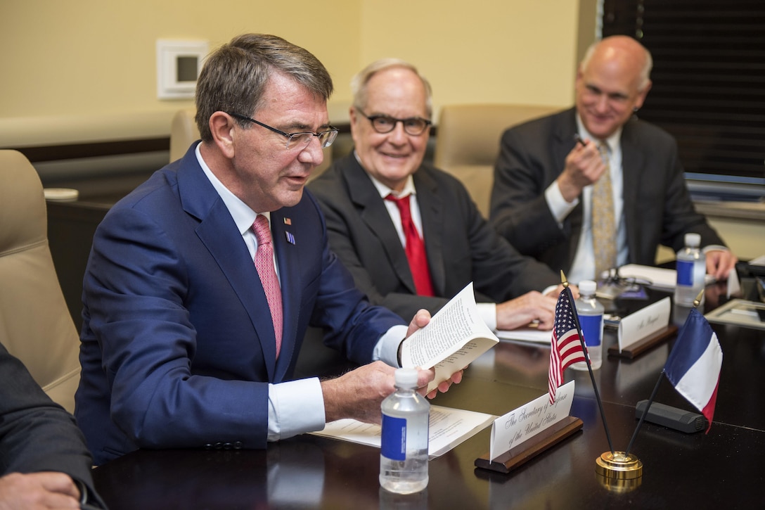Defense Secretary Ash Carter looks at a thank-you gift from author and French Defense Minister Jean-Yves Le Drian during a meeting of defense ministers and senior leaders from the coalition to counter the Islamic State of Iraq and the Levant at Joint Base Andrews, Md., July 20, 2016. DoD photo by Air Force Tech. Sgt. Brigitte N. Brantley