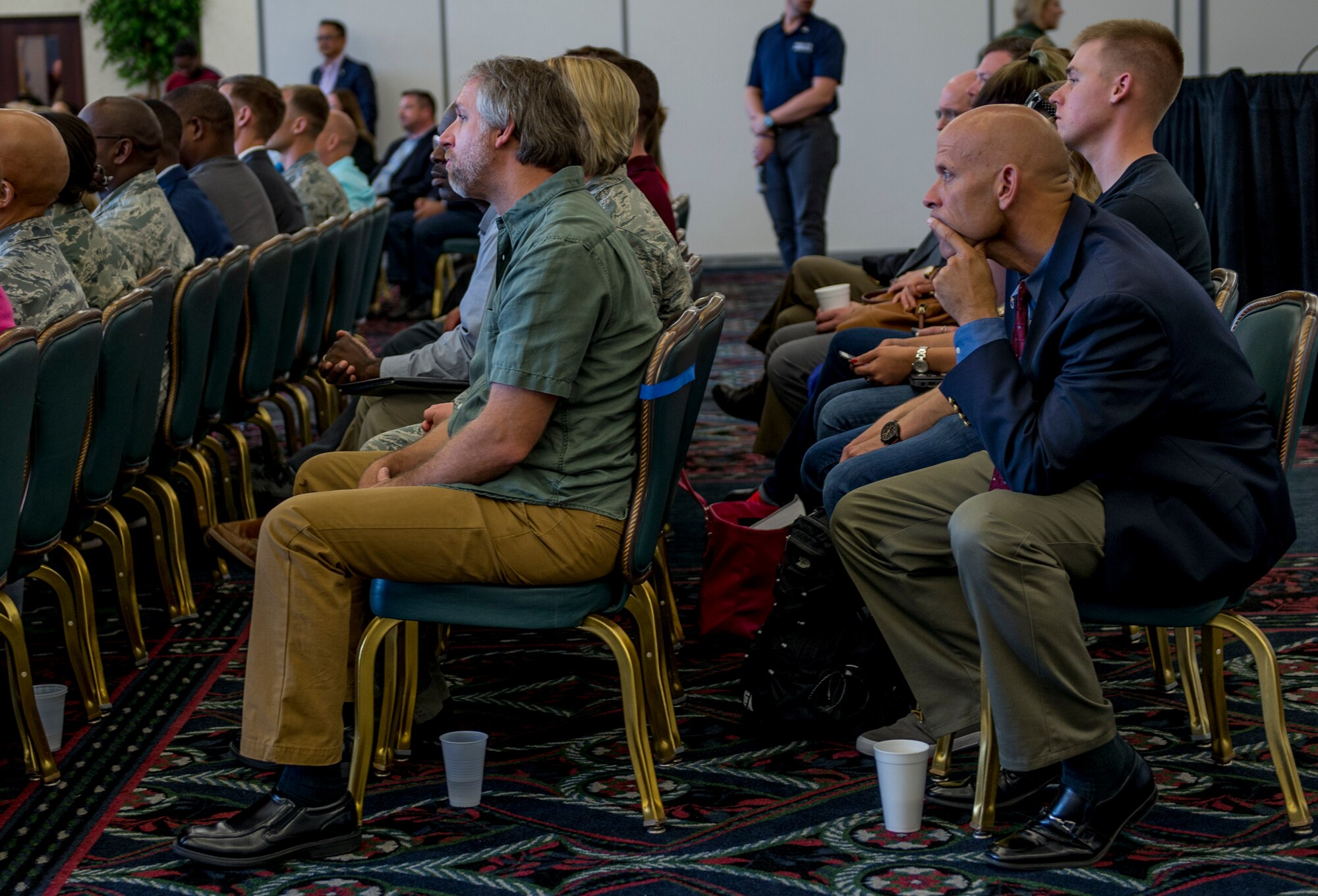 The audience listens to a six-person panel discussion during a two-day transition summit and hiring and education fair for transitioning members, veterans, and spouses, Scott Air Force Base, Ill., July 12, 2016.  The first day of the transition summit offered industry briefs from Microsoft, the 375th Communications Group, Alcoa, Fastport, and SSM Health to transitioning service members, veterans, and military spouses, followed by a panel discussion with senior leaders of potential employers that answered questions of audience members on the transitioning process. The second day featured employment workshops, another panel discussion on different transition perspectives, and a hiring and education fair.   (U.S. Air Force photo by Staff Sgt. Jodi Martinez/Released)