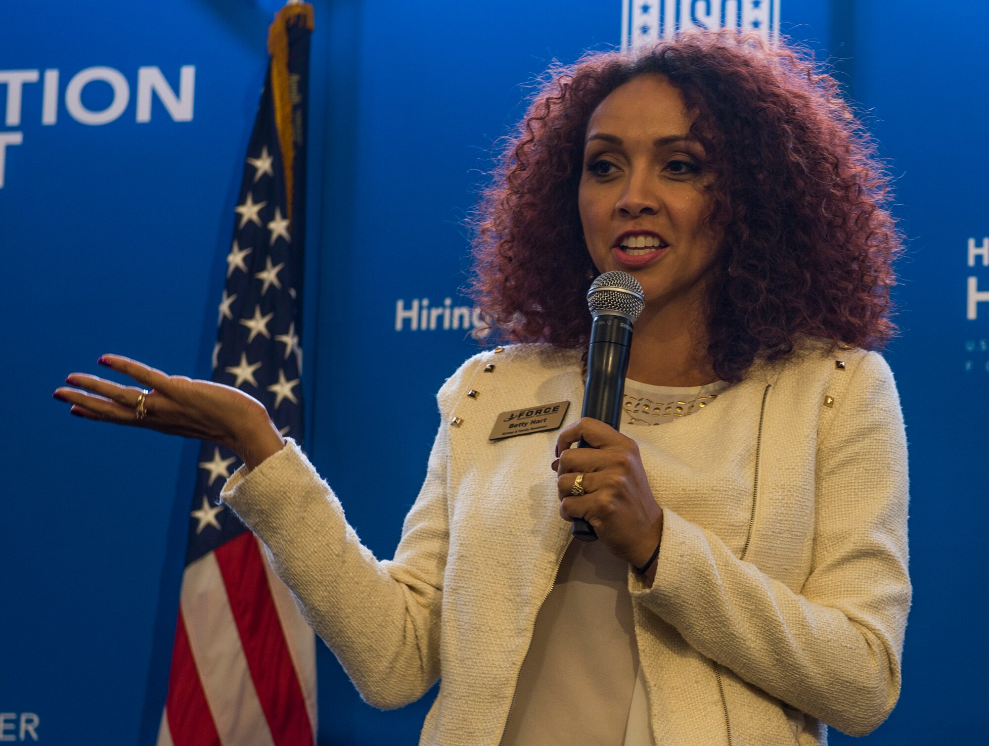 Betty Hart, the Transition Assistance Program manager, speaks during a two-day transition summit and hiring and education fair for transitioning members, veterans, and spouses, Scott Air Force Base, Ill., July 12, 2016. The transition summit offered industry briefs from Microsoft, the 375th Communications Group, Alcoa, Fastport, and SSM Health to transitioning service members, veterans, and military spouses, followed by a panel discussion with senior leaders of potential employers that answered questions of audience members on the transitioning process. The second day featured employment workshops, another panel discussion on different transition perspectives, and a hiring and education fair.   (U.S. Air Force photo by Staff Sgt. Jodi Martinez/Released)