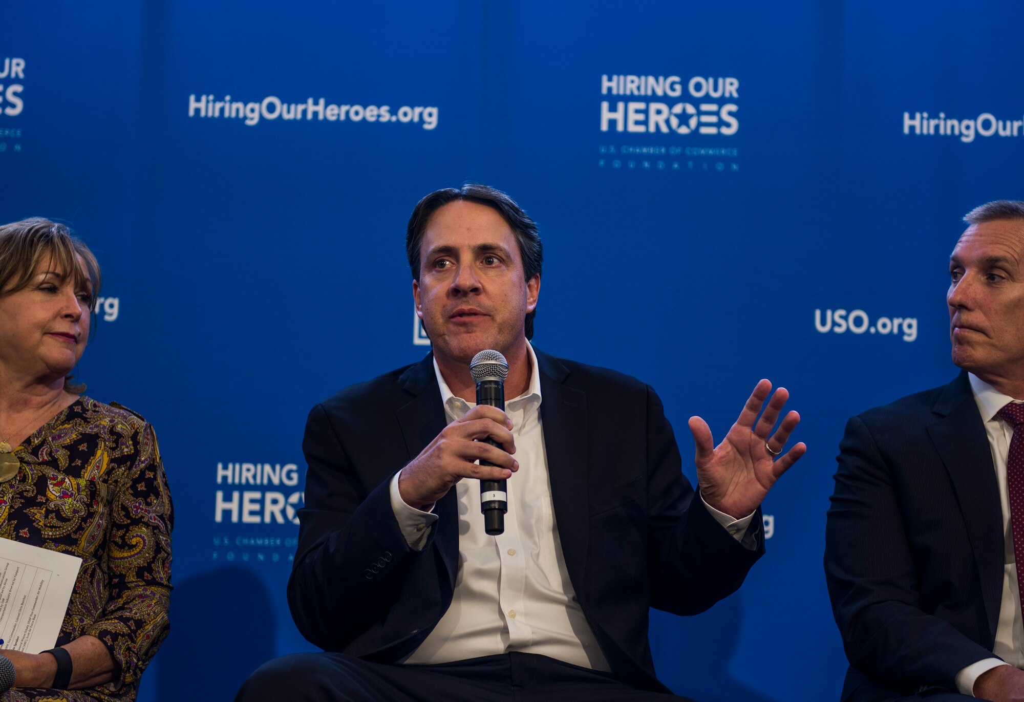 Ray Milano, director of the Veteran Business Outreach Center, responds to a question asked to a six person panel discussion during a two-day transition summit and hiring and education fair for transitioning members, veterans, and spouses, Scott Air Force Base, Ill., July 12, 2016.  The first day of the transition summit offered industry briefs from Microsoft, the 375th Communications Group, Alcoa, Fastport, and SSM Health to transitioning service members, veterans, and military spouses, followed by a panel discussion with senior leaders of potential employers that answered questions of audience members on the transitioning process. The second day featured employment workshops, another panel discussion on different transition perspectives, and a hiring and education fair.   (U.S. Air Force photo by Staff Sgt. Jodi Martinez/Released)