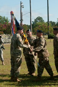 Lt. Col. Christopher W. Warner, outgoing commander of the 2nd Battalion, 345th Regiment, receives the battalion guidon from Command Sgt. Maj. Michael Mew, the outgoing CSM of the 2/345th. Warner has relinquished command to Lt. Col. Augusto Villalaz during a ceremony at Fort Jackson, S.C. July 17. (US Army photo by Sgt. Darryl L. Montgomery, 319th Mobile Public Affairs Detachment)