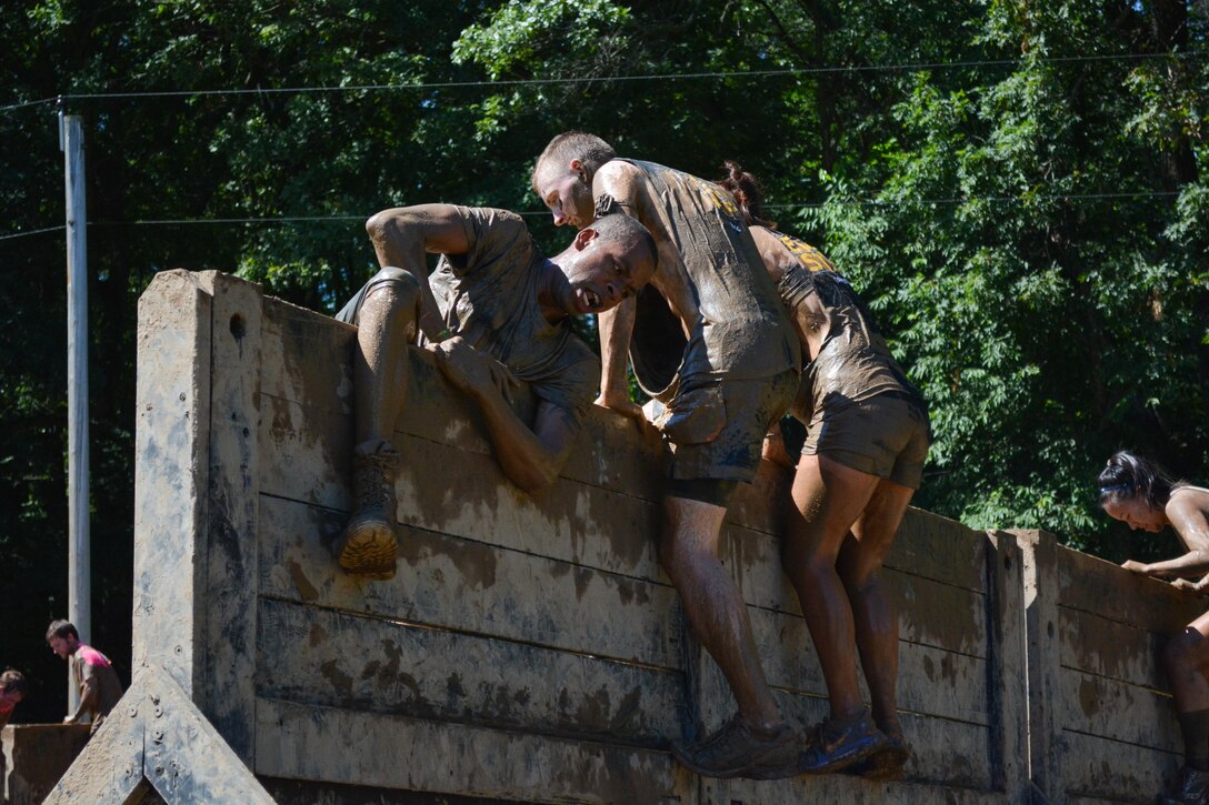 HUGO, Minn. -- The Army Reserve team comprised of Soldiers from the 103rd Sustainment Command (Expeditionary) help each other over the Army Reserve-sponsored, nine-foot “Berlin Wall” during the Tough Mudder held in Hugo, Minnesota, July 17, 2016. This 10-12 mile, military-style obstacle course has challenged more than one million competitors since its inception in 2010, challenging the participant’s strength and stamina while building camaraderie.