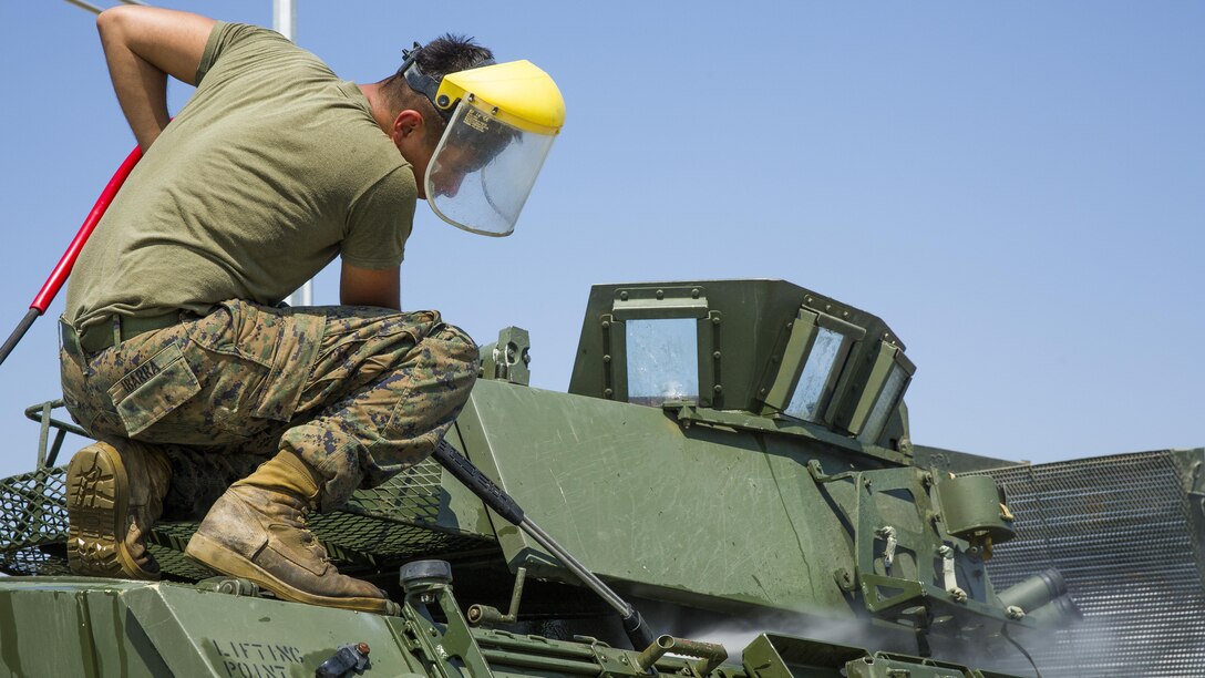 U.S. Marine Corps Lance Cpl. Julian O. Ibarra, a driver with Black Sea Rotational Force, sprays the dirt off a light armored vehicle at the end of Exercise Platinum Lion 16-4 at Novo Selo Training Area, Bulgaria, July 15, 2016. This multi-national exercise brings together eight NATO and partner nations for a live-fire exercise aimed to strengthen regional defense in Eastern Europe. 