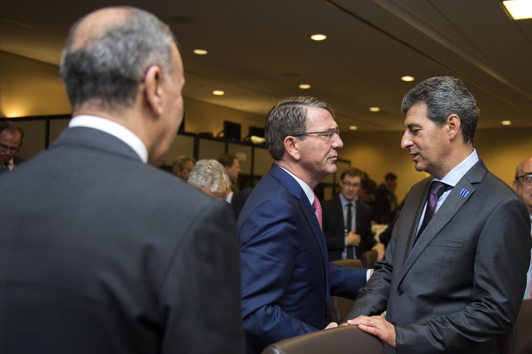 Defense Secretary Ash Carter, middle, and Iraqi Defense Minister Khalid al-Obeidi, left, greet Romanian Defense Minister Mihnea Motoc during a meeting of defense ministers and senior leaders from the coalition to counter the Islamic State of Iraq and the Levant at Joint Base Andrews, Md., July 20, 2016. DoD photo by Air Force Tech. Sgt. Brigitte N. Brantley