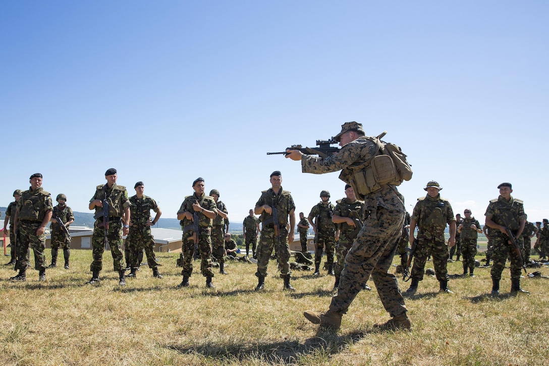 Marine Corps Lance Cpl. Anthony J. Golembeski demonstrates to NATO forces how to properly execute a speed reload during Exercise Platinum Lion 16-4 at Novo Selo Training Area, Bulgaria, July 12, 2016. This multinational exercise brings together eight NATO and partner nations for a live-fire exercise to strengthen regional defense in Eastern Europe. Marine Corps photo by Cpl. Kelly Street