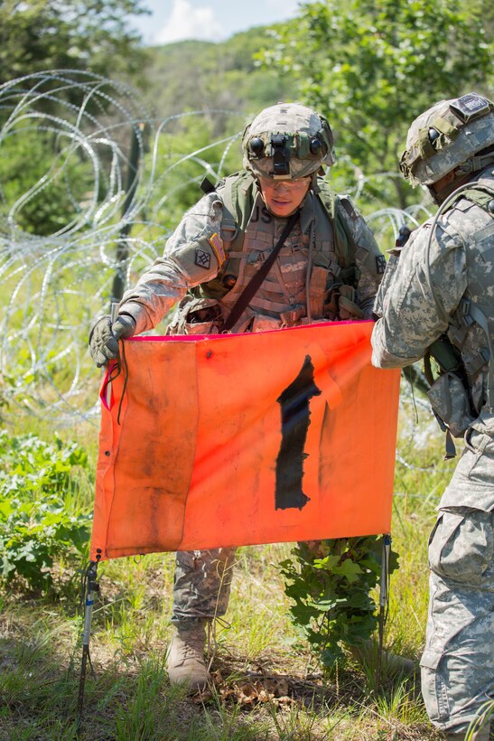 U.S. Army soldiers with the 366th Engineer Company mark a safe lane during a mine clearing exercise during Warrior Exercise (WAREX) 86-16-03 at Fort McCoy, Wis., July 16, 2016. WAREX is designed to keep soldiers all across the United States ready to deploy. (U.S. Army photo by Sgt. Robert Farrell/Released)