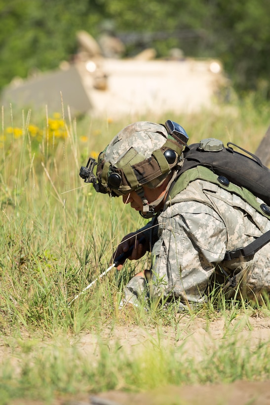 A U.S. Army Soldier with the 366th Engineer Company, Canton, N.Y., searches for inert mines during Warrior Exercise (WAREX) 86-16-03 at Fort McCoy, Wis., July 16, 2016. WAREX is designed to keep soldiers all across the United States ready to deploy. (U.S. Army photo by Sgt. Robert Farrell/Released)