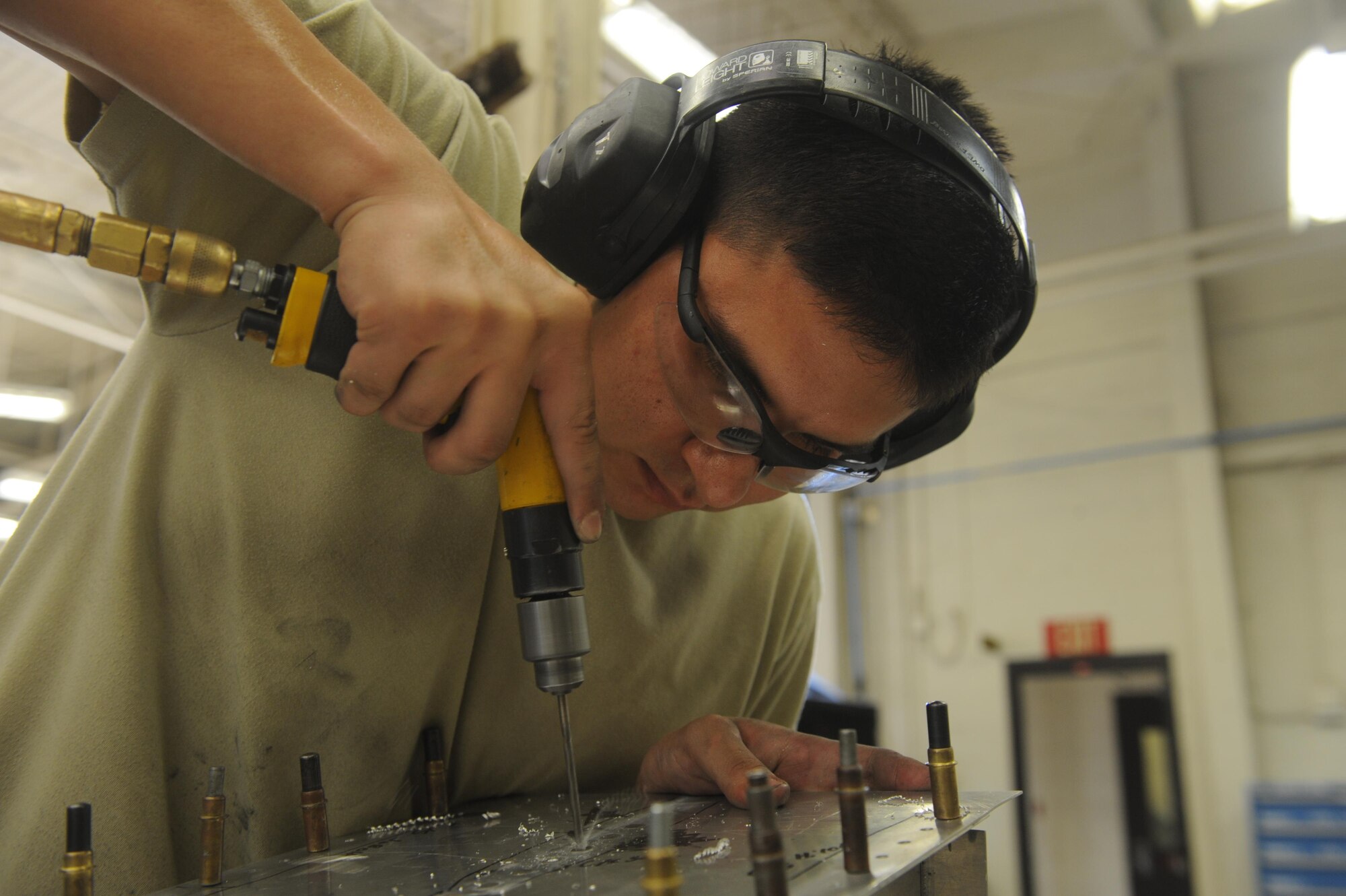 U.S. Air Force Airman 1st Class Miguel Acuna, 7th Equipment Maintenance Squadron aircraft structural maintenance apprentice, drills into a simulated aircraft structure July 1, 2016, at Dyess Air Force Base, Texas. The SAS incorporates various techniques, such as sculpting metal into specific shapes or using specialized drills for Airmen of the sheet metal shop to practice their skills and accomplish on-the-job training. Completing these tasks is necessary to receive their upgrade training certification. (U.S. Air Force photo by Airman 1st Class Rebecca Van Syoc)