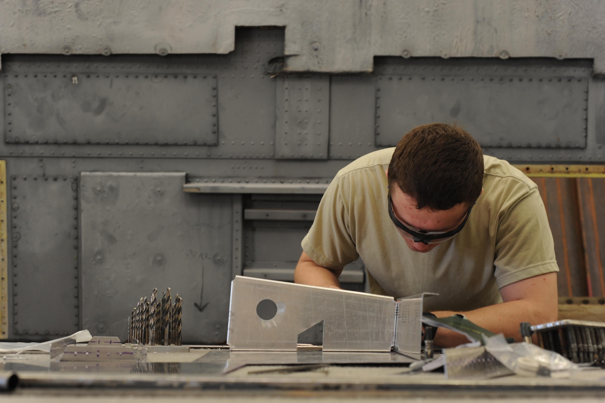 U.S. Air Force Airman 1st Class Jordan Collins, 7th Equipment Maintenance Squadron aircraft structural apprentice, checks the parts of a simulated air structure for correct placement July 7, 2016, at Dyess Air Force Base, Texas. The SAS is an in-depth training project that gives new Airmen the opportunity to practice a variety of techniques, such as identifying materials, drilling, making measurements and correctly forming metal pieces for complex aircraft repairs. (U.S. Air Force photo by Airman 1st Class Rebecca Van Syoc)