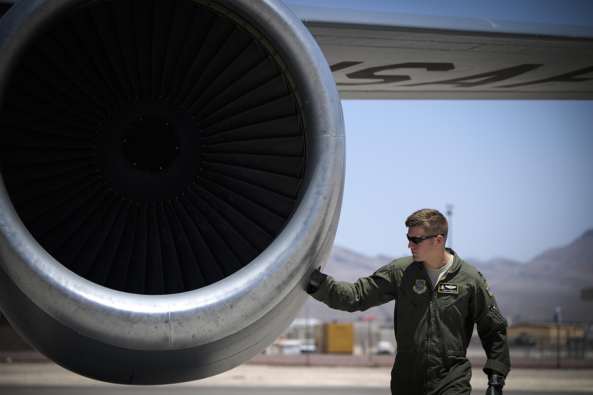 Capt. Dan Fenwick, a KC-135 Stratotanker pilot from MacDill Air Force Base, brushes the outside of an engine during pre-flight checks at Nellis Air Force Base, Nevada July 18, 2015 during exercise Red Flag. Red Flag 16-3 is one of four Red Flag exercises at Nellis--this edition of Red Flag focusing on multi-domain operations in air, space and cyberspace. (U.S. Air Force photo/Tech. Sgt. David Salanitri)