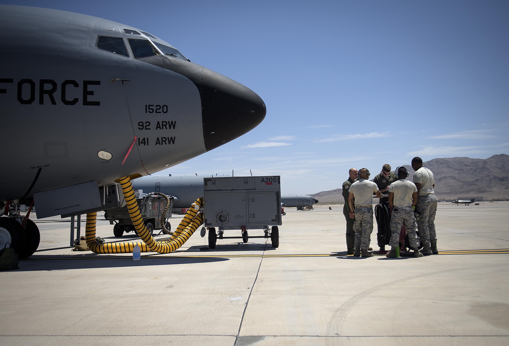 Aircrew and ground personnel conduct a pre-flight check at Nellis Air Force Base, Nevada July 18, 2015 during exercise Red Flag. The aircrew went on to refuel several exercise participants. (U.S. Air Force photo/Tech. Sgt. David Salanitri)