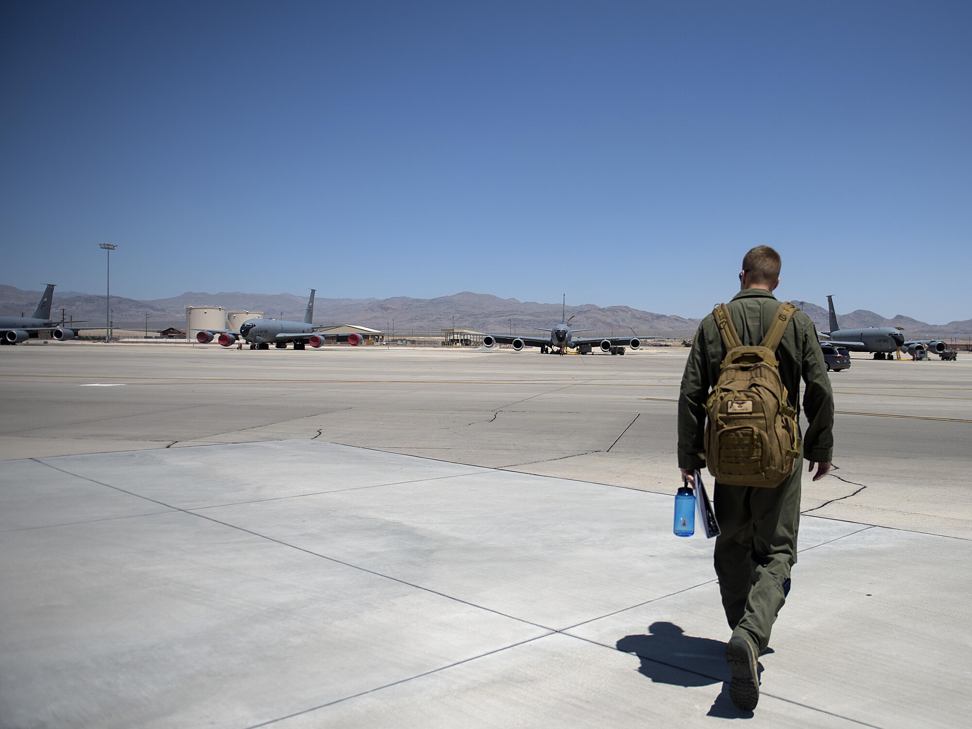 Capt. Dan Fenwick, a KC-135 Stratotanker pilot from MacDill Air Force Base, heads out to his plane for the day at Nellis Air Force Base, Nevada July 18, 2015 during exercise Red Flag. Red Flag 16-3 is one of four Red Flag exercises at Nellis--this edition of Red Flag focusing on multi-domain operations in air, space and cyberspace. (U.S. Air Force photo/Tech. Sgt. David Salanitri)