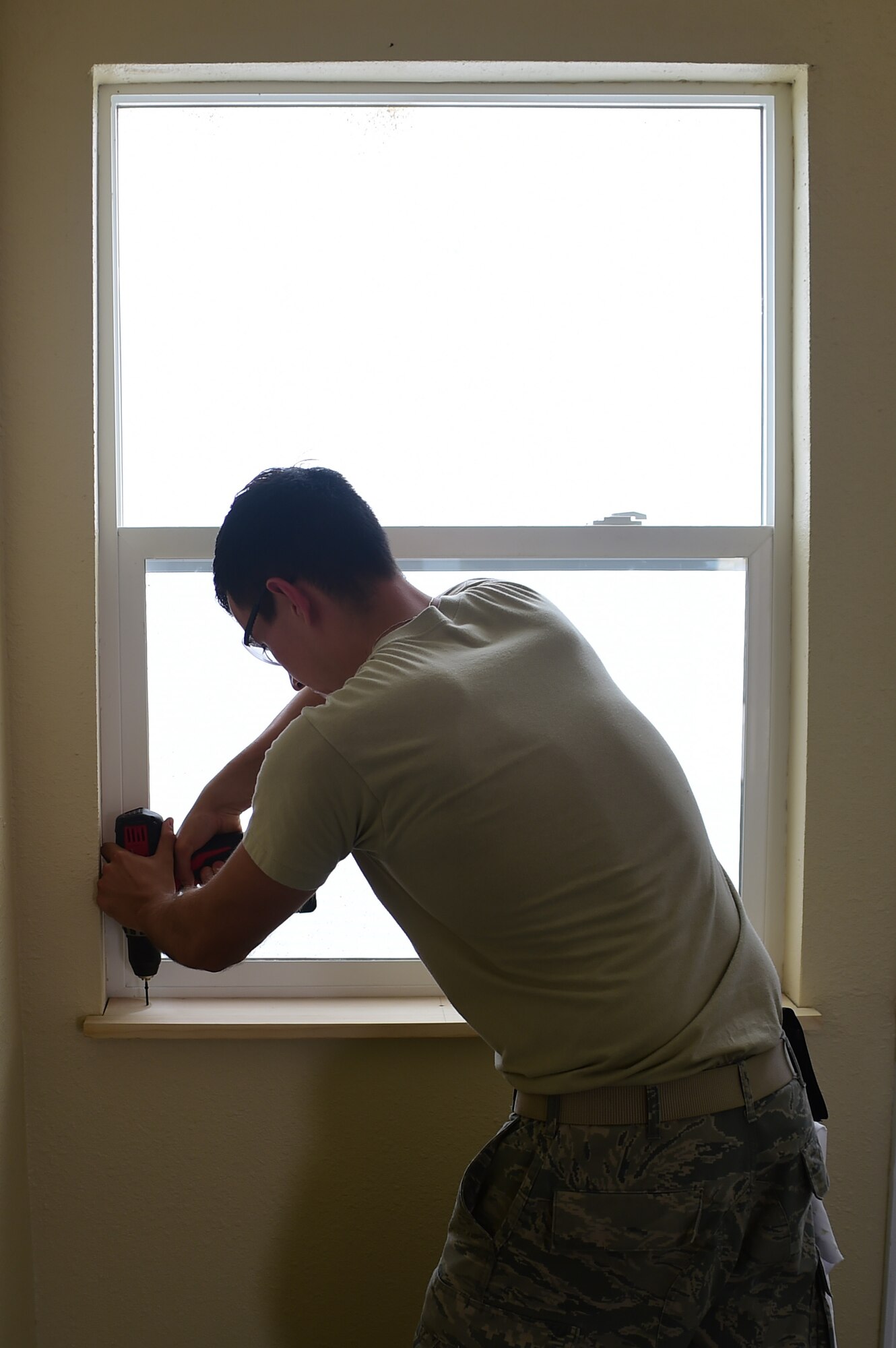 Airman 1st Class Tyler Routt, 460th Civil Engineer Squadron structural maintenance apprentice, uses a power drill to install a window frame July 18, 2016, on Buckley Air Force Base, Colo. The 460th CES renovated a building on base for Cinderella’s Closet, a place where military members and their dependents can buy gently used formal wear for balls and ceremonies. The 460th CES develops, constructs, operates, and sustains the infrastructure on Buckley AFB. (U.S. Air Force photo by Airman 1st Class Luke W. Nowakowski/Released) 