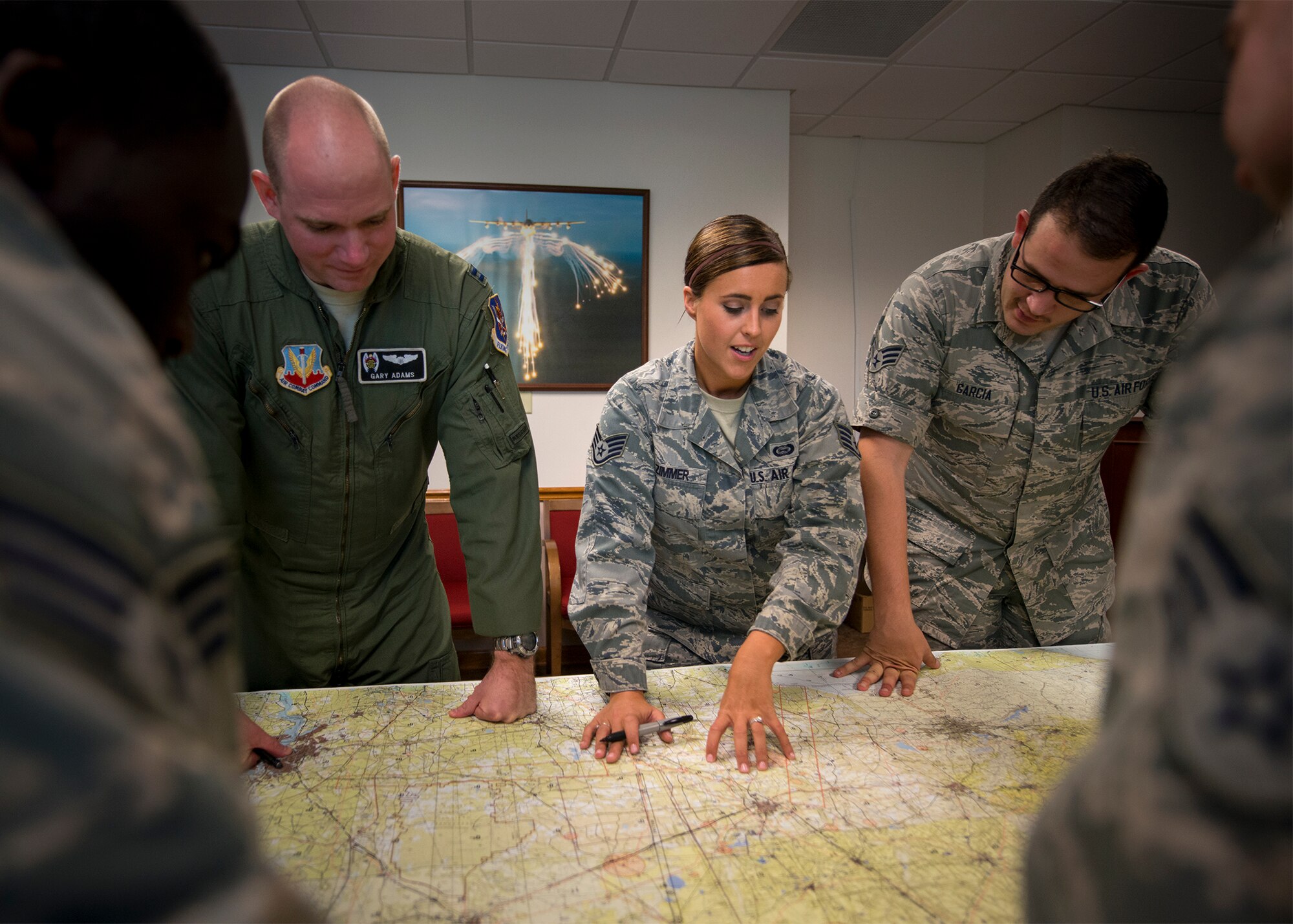 U.S. Air Force Staff Sgt. Jamie Zimmer, 347th Operations Support Squadron intelligence analyst, briefs notable locations on a map, June 29, 2016, at Moody Air Force Base, Ga. The Air Force recently selected Zimmer as one of the service’s 12 Outstanding Airmen of the Year award recipients. (U.S. Air Force photo by Senior Airman Ryan Callaghan)