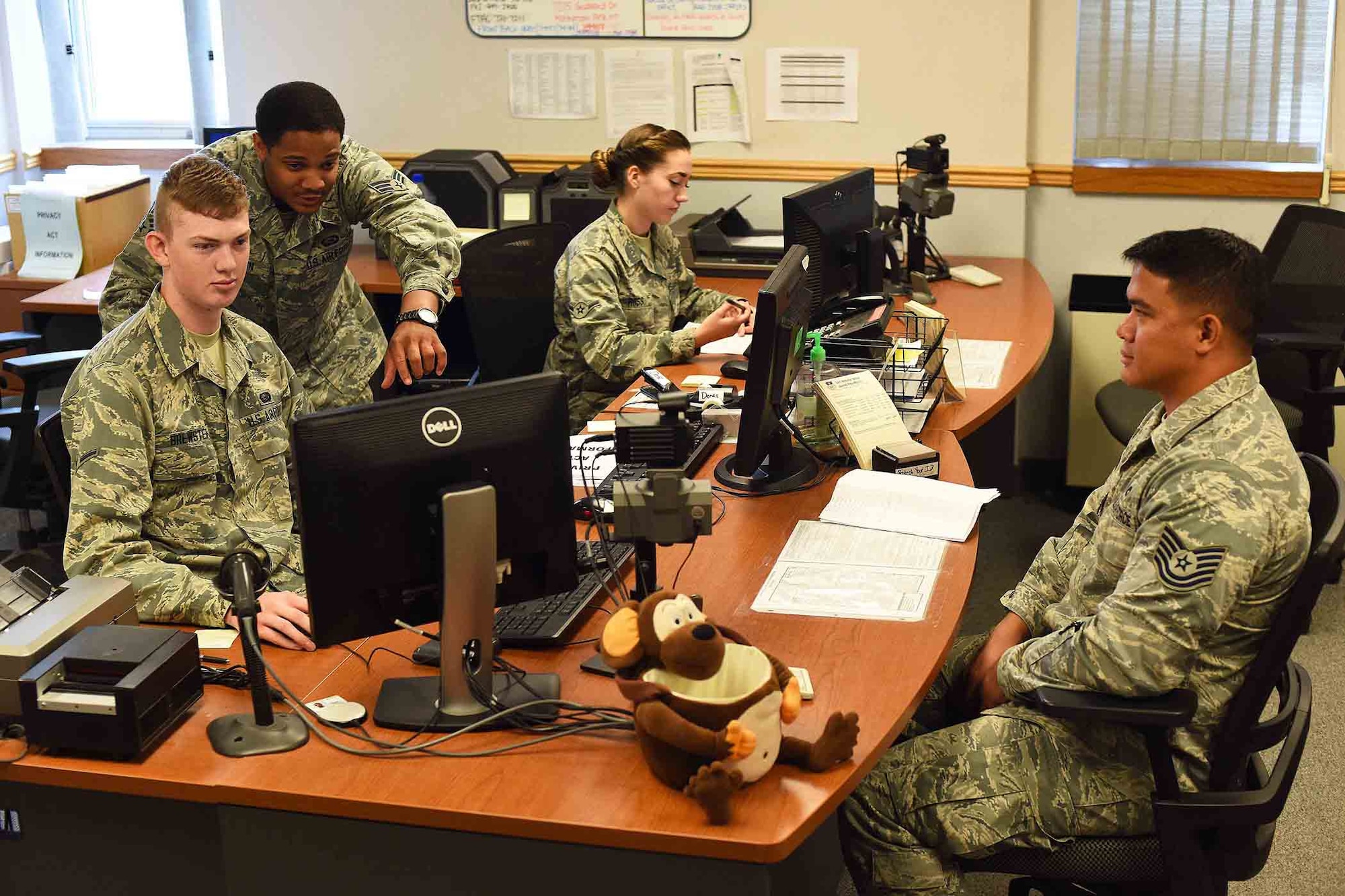 Airmen assigned to the 341st Force Support Squadron customer service section assist a service member July 20, 2016, at Malmstrom Air Force Base, Mont. Customer service is part of the 341st FSS military personnel section, which won a 2015 A1 Award at the Air Force level for outstanding contributions and commitment to excellence in serving Airmen and their families. (U.S. Air Force photo/Amn Collin Schmidt)