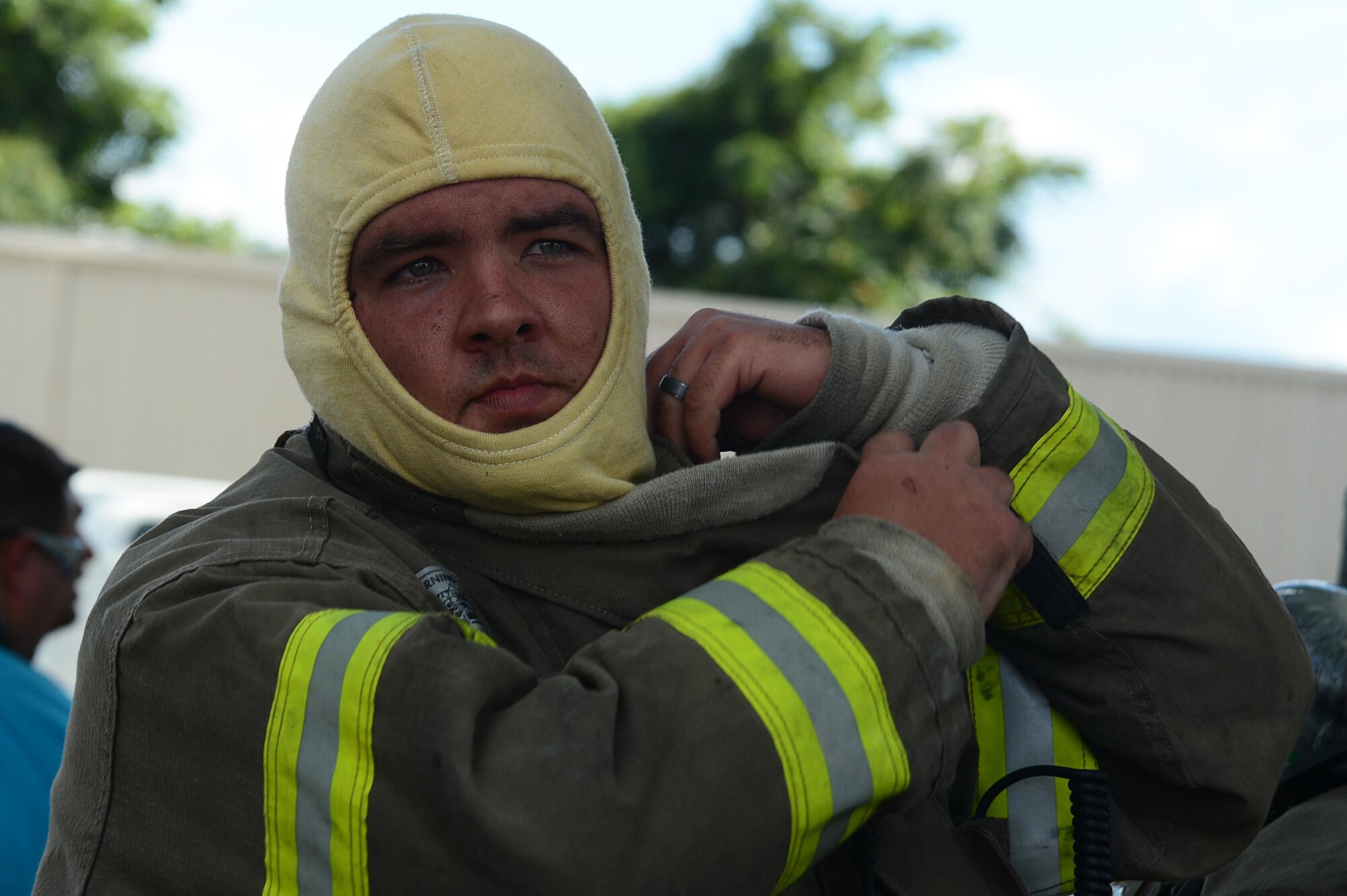A firefighter puts on his protective gear before entering the hot zone in Sumter, S.C., July 18, 2016. The fire took approximately six hours to contain after spreading to multiple buildings. (U.S. Air Force photo by Airman 1st Class Christopher Maldonado)