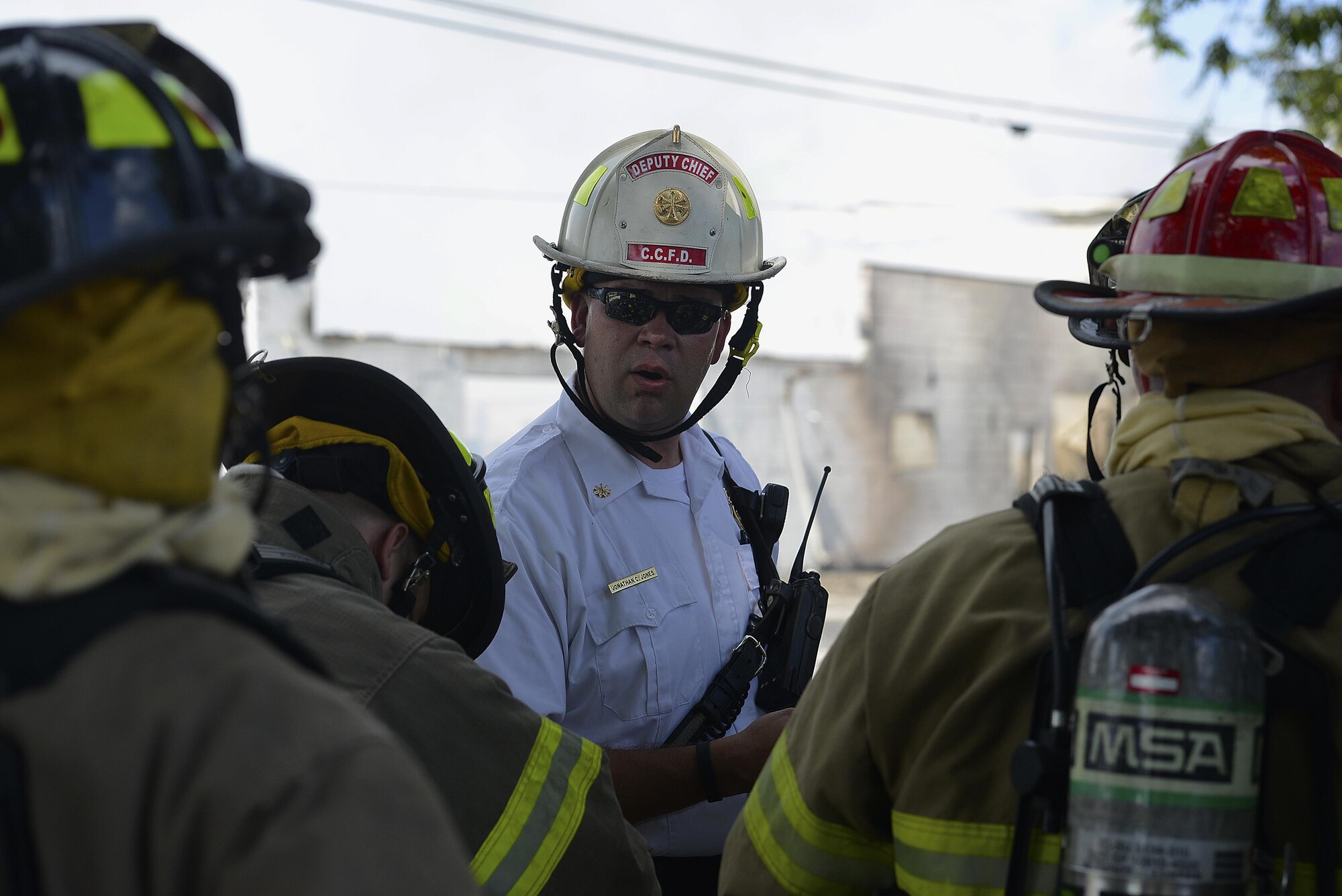 Jonathan Jones, Columbia Fire Department deputy chief, briefs fellow firefighters before entering the hot zone in Sumter, S.C., July 18, 2016. The hot zone is the area surrounding the fire, that firefighters enter to put the fire out. (U.S. Air Force photo by Airman BrieAnna Stillman)