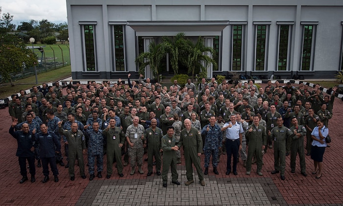 (July 18, 2016) - Participants of Cope Taufan 2016 pose for a photo in front of the 18th Squadron, Royal Malaysian Air Force auditorium building, at Pangkalan Udara Butterworth Air Base, Malaysia, 18 July 2016. Cope Taufan 16 is a PACAF-led exercise that reinforces U.S. Pacific Command Theater Security Cooperation goals for the Southeast Asian region and demonstrates U.S. capability to project forces strategically in a combined, joint environment.  More than 450 Airmen are participating, as well as four U.S. Air Force airframes.