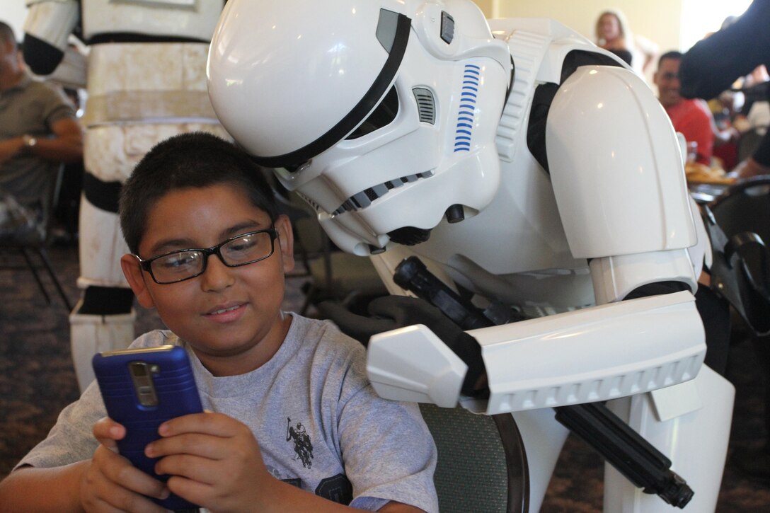A Star Wars Storm Trooper takes a selfie with a child during Recruiting Station Los Angeles’ Family Day at Naval Base Ventura County Port Hueneme, July 16, 2016. During the family day, volunteers from the 501st Legion Southern California Garrison dressed up as Star Wars characters, interacting with families. (U.S. Marine Corps photo by Staff Sgt. Alicia R. Leaders/Released)