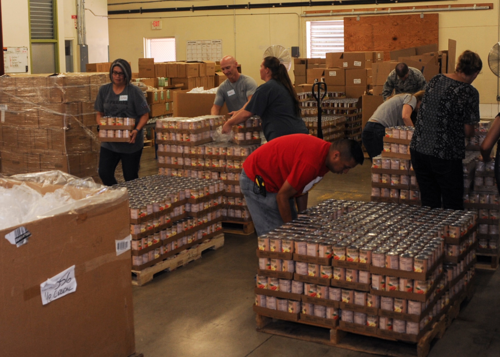 U.S. Airmen and civilians from the 355th Comptroller Squadron volunteer at the Food Bank of Southern Arizona, in Tucson, Ariz., July 14, 2016. They participated in a three hour volunteer shift, which involved sorting and boxing different kinds of nonperishable foods. (U.S. Air Force photo by Airman Nathan H. Barbour/Released)