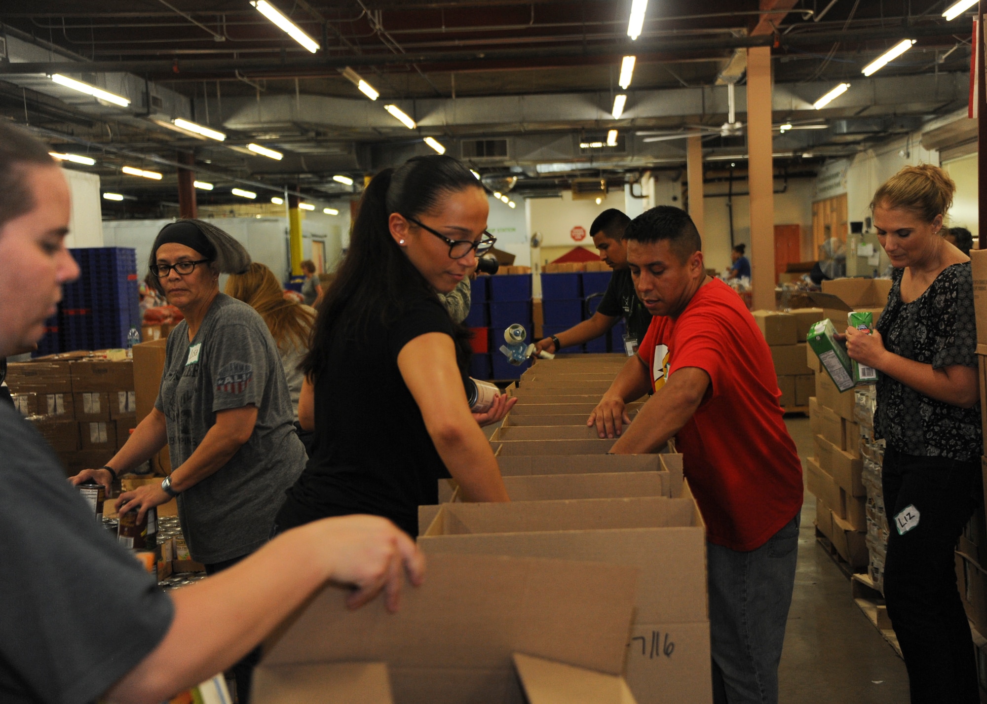 U.S. Airmen and civilians from the 355th Comptroller Squadron volunteer at the Food Bank of Southern Arizona, Ariz., in Tucson, July 14, 2016. They participated in a three hour volunteer shift, which involved sorting and boxing different kinds of nonperishable foods. (U.S. Air Force photo by Airman Nathan H. Barbour/Released)
