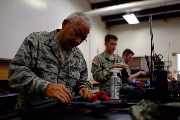 Hawaii Air National Guard Colonel Kyle Yanagisawa cleans his M4 Carbine rifle after the Excellence in Competition M4 event on July 15, 2016 at Schofield Barracks, Hawaii. The event, which was held July 13-15 at the 647th SFS Combat Arms Firing Range, allowed would-be marksmen to test their abilities while using the Air Force standard-issue M4 carbine rifle. (U.S Air Force photo by Staff Sgt. Christopher Stoltz)
