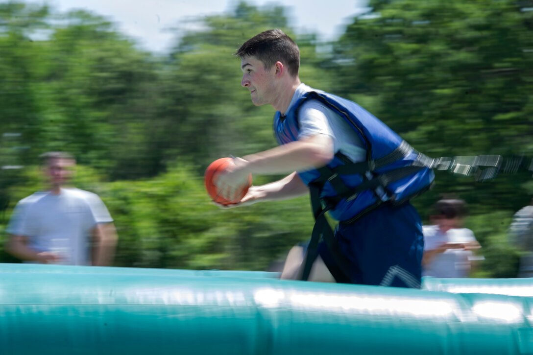 Airman 1st Class Cole Sechrest, 779th Medical Squadron medical technician, pulls his way to a slam dunk on “Bungee Basketball” during the annual dorm challenge held on Joint Base Andrews, Md., July 15, 2016. The event was hosted by the installation’s Airmen Committed to Excellence club and supported by the USO. The event was created to enhance morale for JBA Airmen. (U.S. Air Force photo by Airman Gabrielle Spalding)