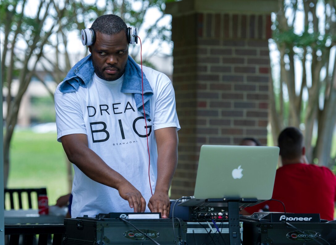 Jude Jean, a former Tech. Sgt., now an independent disc jockey, played music during the annual dorm challenge event held on Joint Base Andrews, Md., July 15, 2016. The event was hosted by the installation’s Airmen Committed to Excellence club and supported by the USO. Festivities included a disc jockey, free food and drinks, volleyball, cornhole and an array of inflatable obstacles. (U.S. Air Force photo by Airman Gabrielle Spalding)