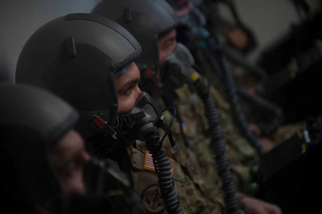Capt. Raylind Bergman, 1st Helicopter Squadron instructor pilot and operations assistant flight commander, participates in altitude chamber training supervised by his wife, 1st Lt. Alethea Bergman, 79th Medical Wing aerospace and operational physiologist and operations element chief, at Joint Base Andrews, Md., July 6, 2016. The couple met in ROTC, married in 2010, and attributes their success both in the Air Force and in their marriage to their multiple shared common goals and ambitions. (U.S. Air Force photo by Senior Airman Mariah Haddenham)