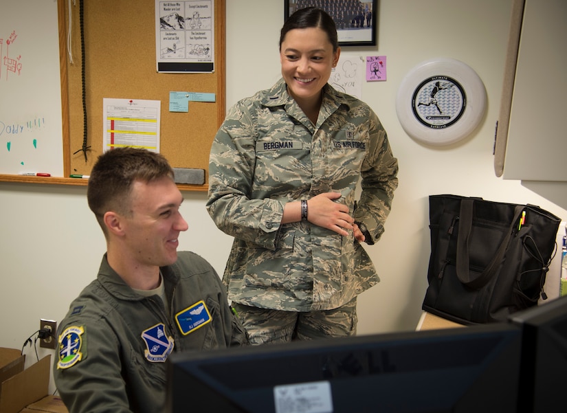 Capt. Raylind Bergman, 1st Helicopter Squadron instructor pilot and operations assistant flight commander, spends time with his wife, 1st Lt. Alethea Bergman, 79th Medical Wing aerospace and operational physiologist and operations element chief, before altitude chamber training at Joint Base Andrews, Md., June 28, 2016. The couple met in ROTC, married in 2010, and attributes their success both in the Air Force and in their marriage to their multiple shared common goals and ambitions. (U.S. Air Force photo by Senior Airman Mariah Haddenham)