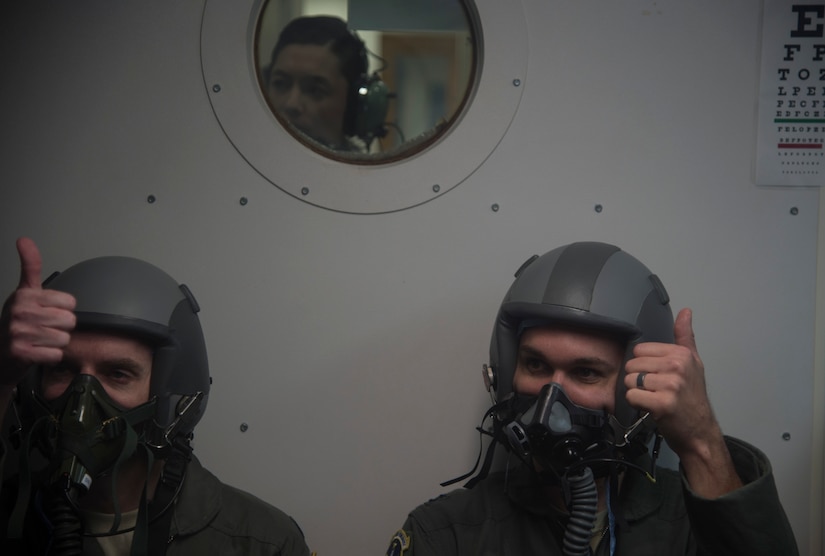 Capt. Raylind Bergman, 1st Helicopter Squadron instructor pilot and operations assistant flight commander, participates in altitude chamber training with the help of his wife, 1st Lt. Alethea Bergman, 79th Medical Wing aerospace and operational physiologist and operations element chief, at Joint Base Andrews, Md., July 6, 2016. The couple met in ROTC, married in 2010, and attributes their success both in the Air Force and in their marriage to their multiple shared common goals and ambitions. (U.S. Air Force photo by Senior Airman Mariah Haddenham)