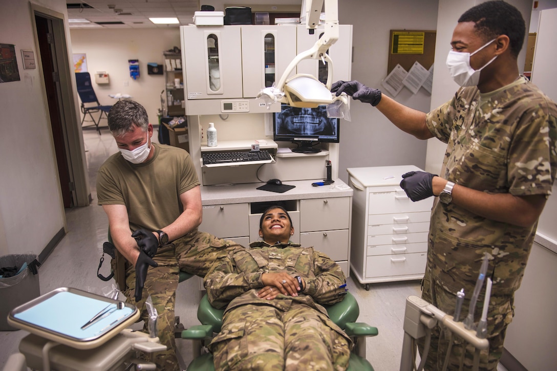 Army Capt. John Mann, left, prepares dental instruments for patient exams at Bagram Airfield in Afghanistan, July 16, 2016. Mann is a dentist assigned to the 129th Area Support Medical Company. Air Force photo by Senior Airman Justyn M. Freeman