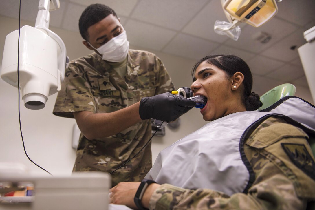 Army Spc. Anfernee Grant places a periapical X-ray device, which detects unusual changes in the root and surrounding bone structure, in a patient’s mouth at Bagram Airfield in Afghanistan, July 16, 2016. Grant is a dental technician assigned to the 129th Area Support Medical Company. Air Force photo by Senior Airman Justyn M. Freeman