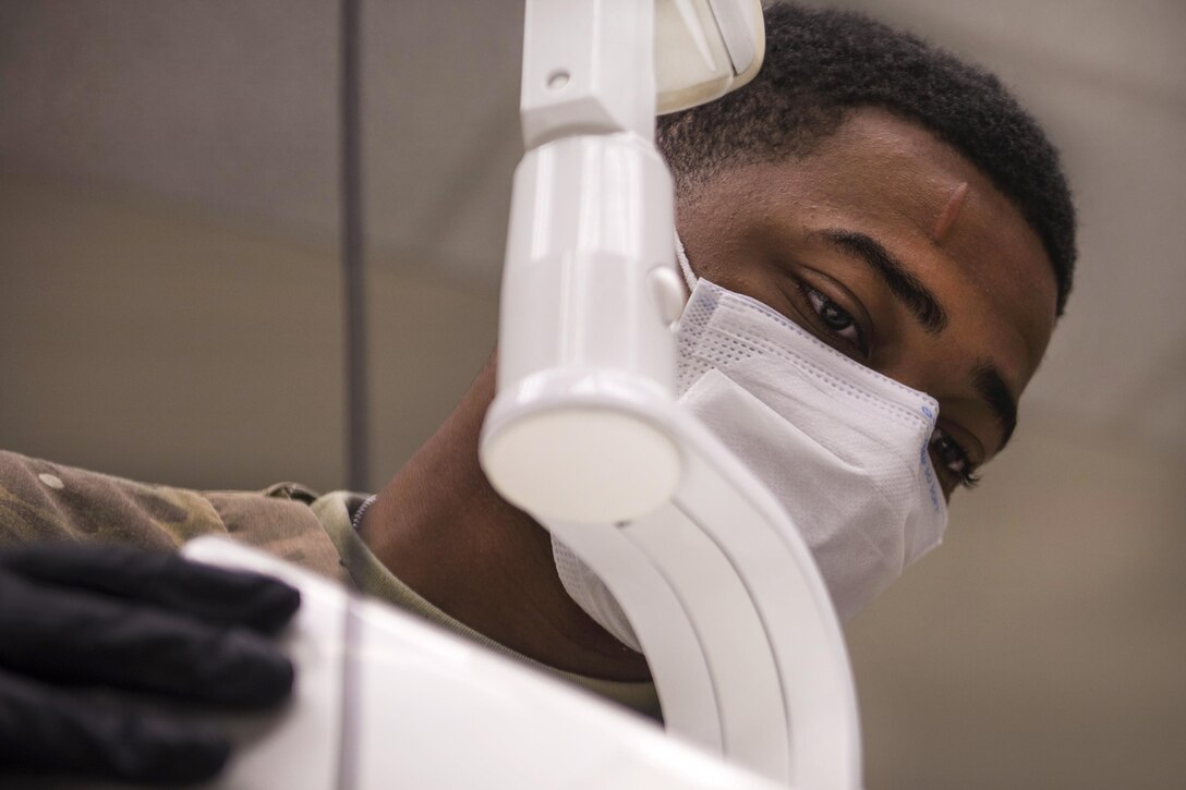 Army Spc. Anfernee Grant prepares a periapical X-ray device for a patient at Bagram Airfield, Afghanistan, July 16, 2016. Grant is a dental technician assigned to the 129th Area Support Medical Company. Air Force photo by Senior Airman Justyn M. Freeman