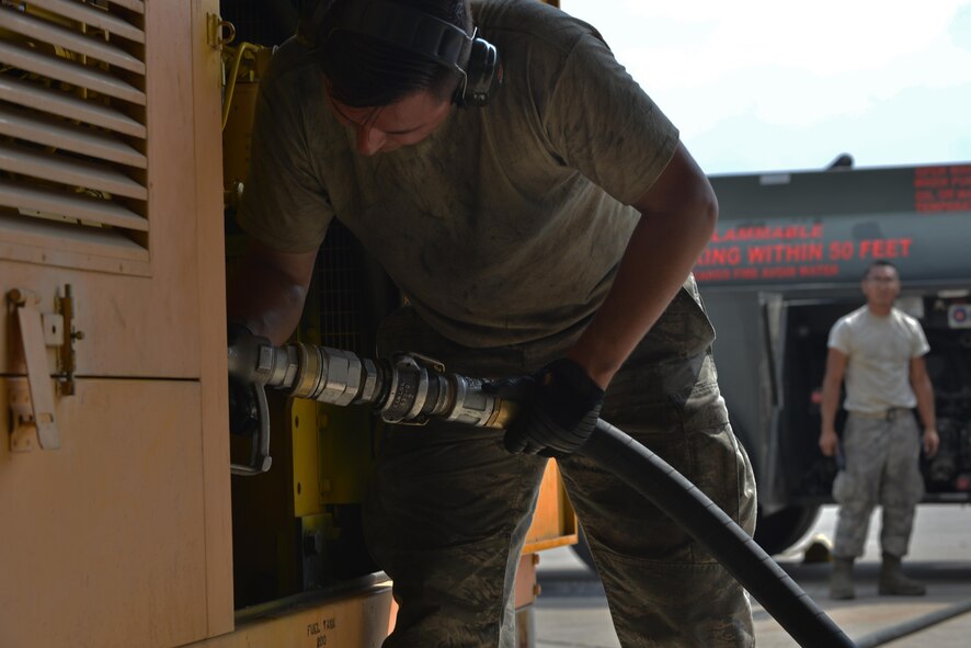 U.S. Air Force Airman 1st Class Trenton Beard and Eduardo Reyes, 39th Logistics Readiness Squadron fuels specialists, refuel a generator July 19, 2016, at Incirlik Air Base, Turkey. Fuels specialists maintain and operate petroleum equipment and facilities. (U.S. Air Force photo by Senior Airman John Nieves Camacho) 