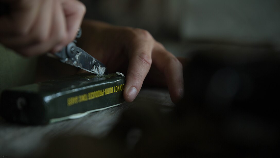 A Marine with 2nd Explosive Ordnance Disposal Company, 8th Engineer Support Battalion cuts out a measured amount of C4 for a charge during a training exercise at Marine Corps Base Camp Lejeune, N.C., July 19, 2016. The unit conducted the training to test the effects of different types of excavation charges. 