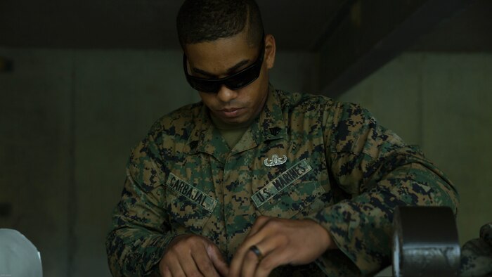 Sgt. Anthony Carbajal, an explosive ordnance disposal team leader with 2nd EOD Company, 8th Engineer Support Battalion, molds two pieces of C2 during a training exercise at Marine Corps Base Camp Lejeune, N.C., July 19, 2016. The unit conducted the training to test the effects of different types of excavation charges.