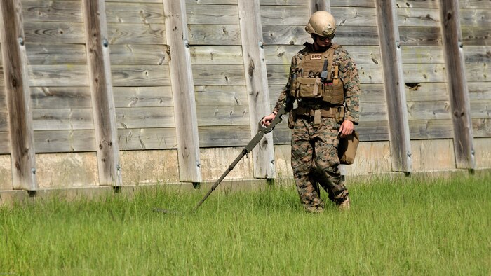 Sgt. David Jones, an explosive ordnance disposal team leader with 2nd EOD Company, 8th Engineer Support Battalion, scans the EOD lane for signs of an improvised explosive device during a training exercise at Marine Corps Base Camp Lejeune, N.C., July 19, 2016. The unit conducted the training to test the effects of different types of excavation charges. (U.S. Marine Corps photo by Lance Cpl. Victoria Ross)