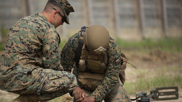 Sgt. Derek Turner, an explosive ordnance disposal technician with 2nd EOD Company, 8th Engineer Support Battalion, observes as Sgt. Anthony Carbajal digs around a controlled improvised explosive device during a training exercise at Marine Corps Base Camp Lejeune, N.C., July 19, 2016. The unit conducted the training to test the effects of different types of excavation charges. 