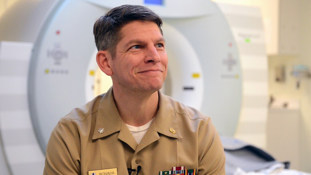 Navy Cmdr. (Dr.) Grant Bonavia, interim chief of the department of research and chief of neuroimaging and measurement devices at the National Intrepid Center of Excellence in Bethesda, Md., talks about the technology he uses to help service members and veterans with traumatic brain injuries. DoD photo by Navy Petty Officer 2nd Class Darien Kenney