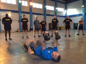 Army Command Sgt. Maj. John Wayne Troxell, right, the senior enlisted advisor to the chairman of the Joint Chiefs of Staff, leads an intense, early morning workout session